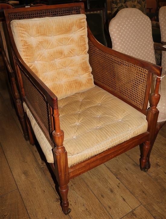 An Edwardian Sheraton style satinwood bergere armchair, W.2ft D.2ft 5in. H.3ft 3in.